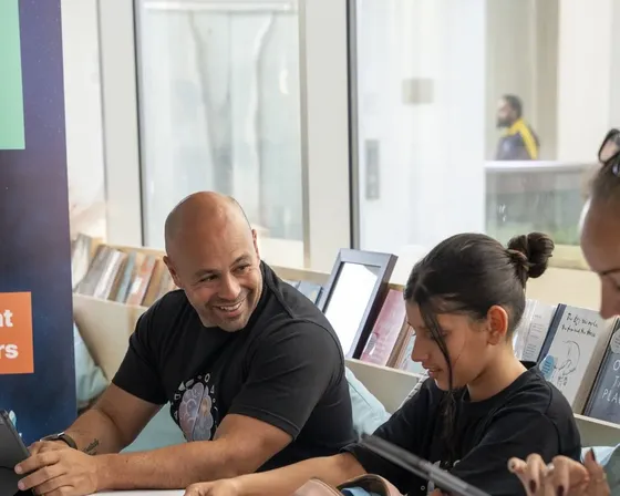 A parent working through a lesson alongside their child